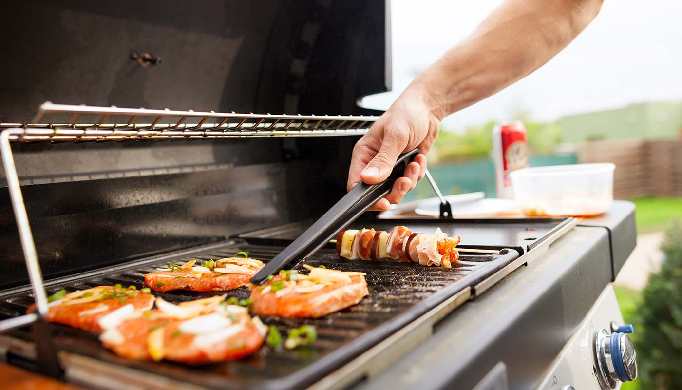 close up of man grilling food outdoors
