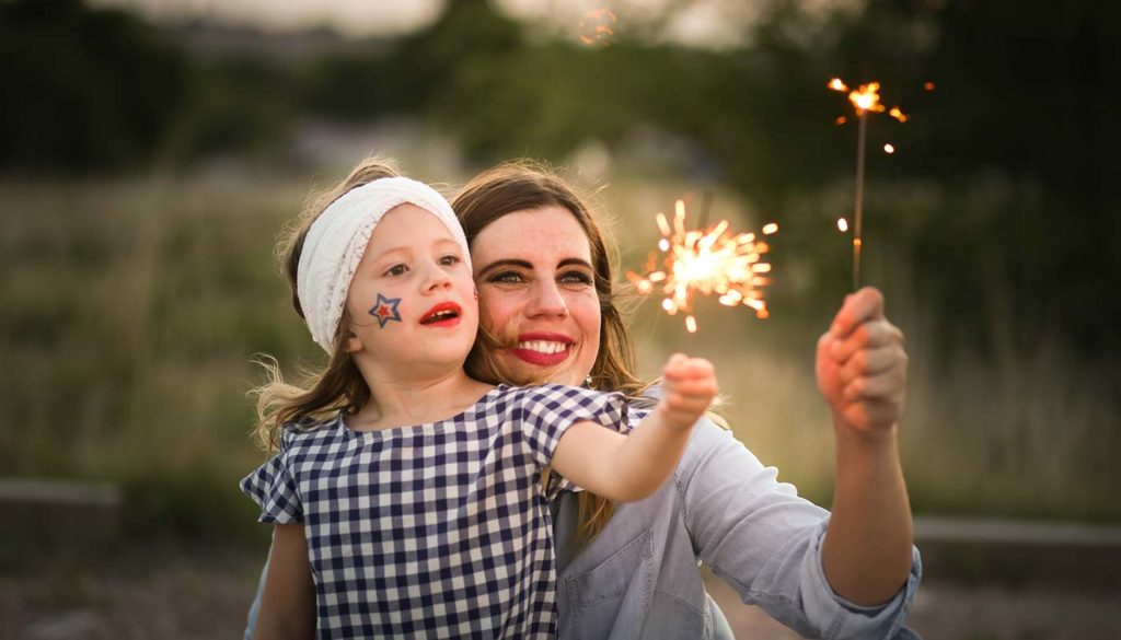 mother and daughter enjoying sparklers together