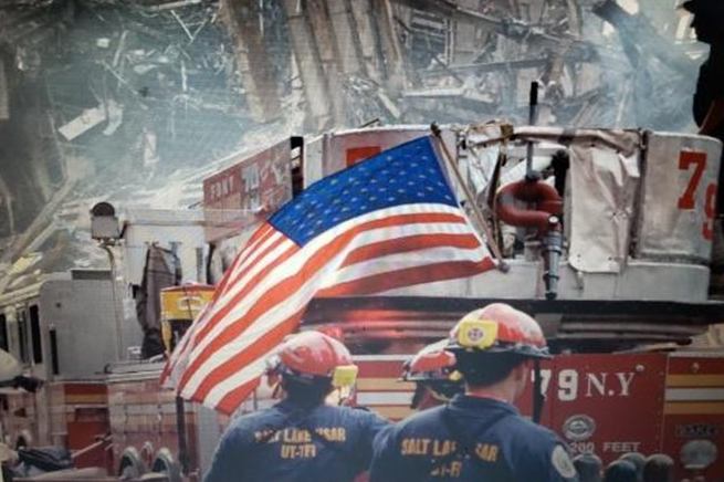 Firefighters standing in front of flag during 9/11 response