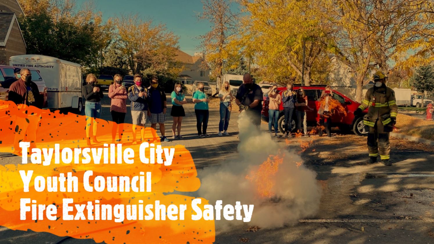 "Taylorsville City Youth Council Fire Extinguisher Safety" firefighter sprays fire with fire extinguisher